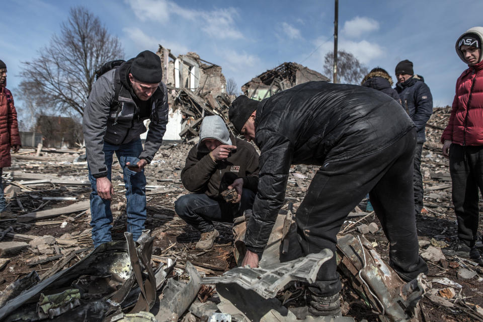 People sift through debris after a Russian cruise missile allegedly hit a secondary school in Merefa, near Kharkiv, Ukraine, March 17, 2022. / Credit: Andrea Carrubba/Anadolu Agency/Getty