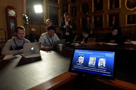 The names of Rainer Weiss, Barry C. Barish and Kip S. Thorne are displayed on the screen during the announcement of the winners of the Nobel Prize in Physics 2017, in Stockholm, Sweden, October 3, 2017. TT News Agency/Jessica Gow via REUTERS