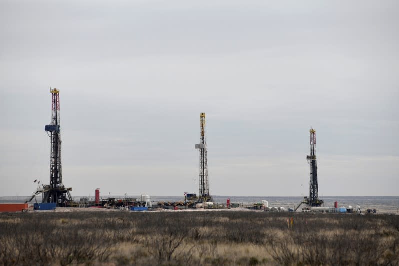 FILE PHOTO: Drilling rigs operate in the Permian Basin oil and natural gas production area in Lea County