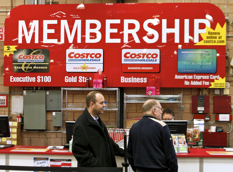 In a photo made on Monday, Feb. 28, 2011, Consumers apply for Costco membership at the Costco Wholesale store in Glendale, Calif.  Costco's fiscal third-quarter net income climbed 19 percent on lower asset charges and the wholesale club pulled in more money from membership fees. (AP Photo/Damian Dovarganes)