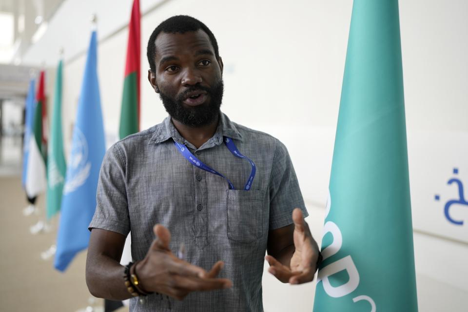 Joseph Kenson Sakala, a farmer from Malawi, talks about how fossil fuel extraction polluted his soil and water sources at the COP28 U.N. Climate Summit, Monday, Dec. 11, 2023, in Dubai, United Arab Emirates. Sakala is sharing the story of how fossil fuel development upended his life — and hoping that negotiators listen to many such stories and then move decisively to cut use of the coal, oil and gas warming the planet.(AP Photo/Rafiq Maqbool)