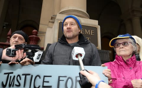 Protesters celebrate outside of the Supreme Court of Victoria as Cardinal George Pell loses his appeal - Credit: Getty