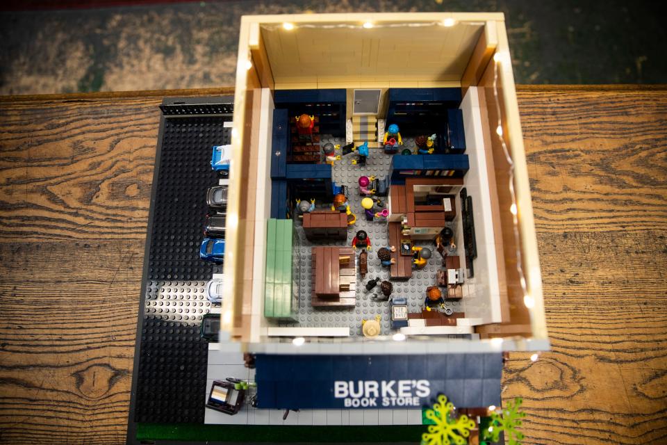 Cheryl Mesler, co-owner of Burke's Book Store, builds a Lego replica model of the store on Nov. 9, 2022, in Memphis.