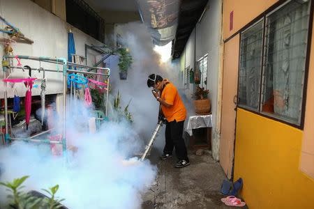 A city worker fumigates the area to control the spread of mosquitoes at a university in Bangkok, Thailand, September 13, 2016. Picture taken September 13, 2016. REUTERS/Athit Perawongmetha