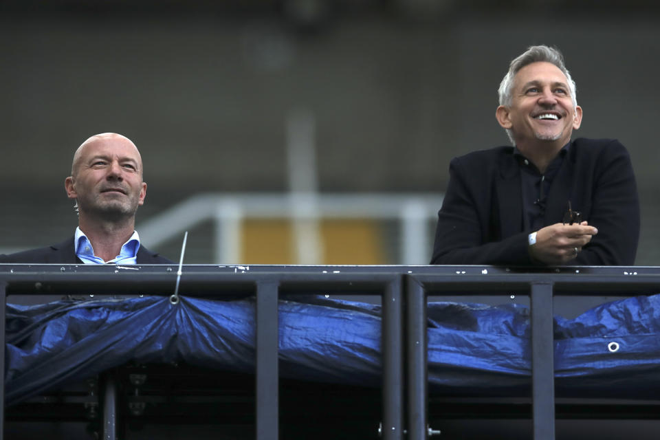 FILE - TV soccer pundits and former soccer players Alan Shearer, left, and Gary Lineker watch the FA Cup sixth round soccer match between Newcastle United and Manchester City at St. James' Park in Newcastle, England, Sunday, June 28, 2020. (Shaun Botterill/Pool via AP, File)