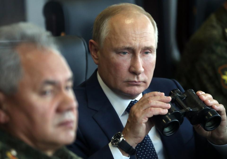 Russian President Vladimir Putin, right, holds a binoculars as Russian Defense Minister Sergei Shoigu sits near watching the joint strategic exercise of the armed forces of the Russian Federation and the Republic of Belarus Zapad-2021 at the Mulino training ground in the Nizhny Novgorod region, Russia, Monday, Sept. 13, 2021. The military drills attend by servicemen of military units and divisions of the Western Military District, representatives of the leadership headquarters and personnel of military contingents of the armed forces of Armenia, Belarus, India, Kazakhstan, Kyrgyzstan and Mongolia. (Sergei Savostyanov, Sputnik, Kremlin Pool Photo via AP)