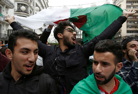 A student carries an Algerian flag and shouts slogans during a protest calling on President Abdelaziz Bouteflika to quit, in Algiers, Algeria March 26, 2019. REUTERS/Ramzi Boudina