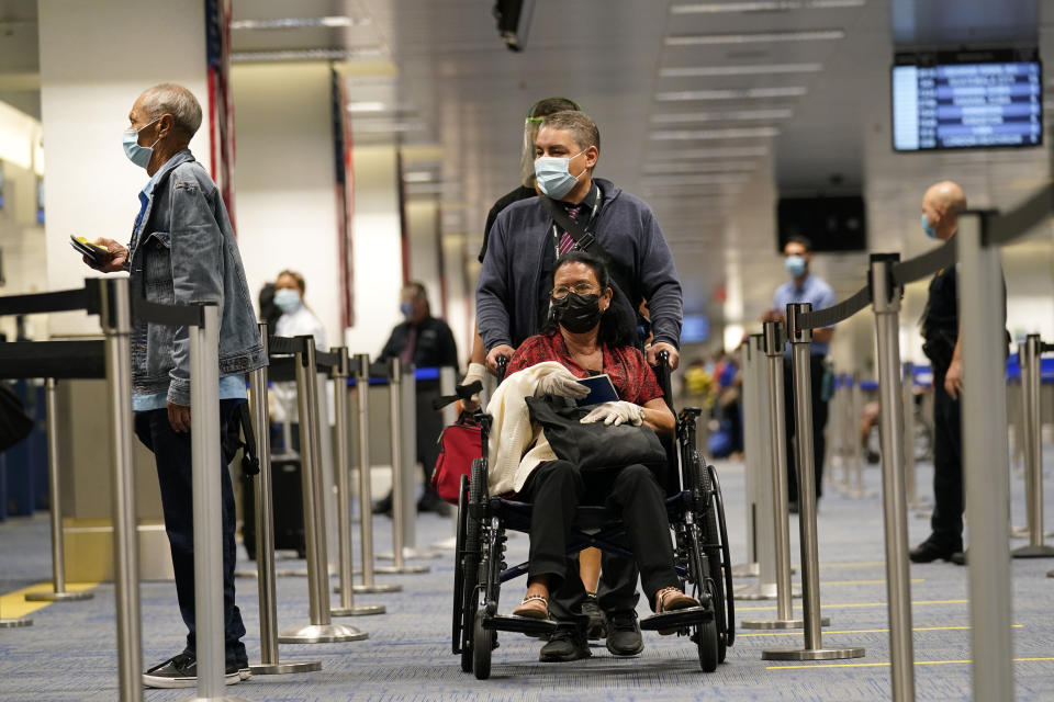 International passengers arrive at Miami international Airport where they are screened by U.S. Customs and Border Protection (CBP) using facial biometrics to automate manual document checks required for admission into the U.S. Friday, Nov. 20, 2020, in Miami. Miami International Airport is the latest airport to provide Simplified Arrival airport-wide. (AP Photo/Lynne Sladky)