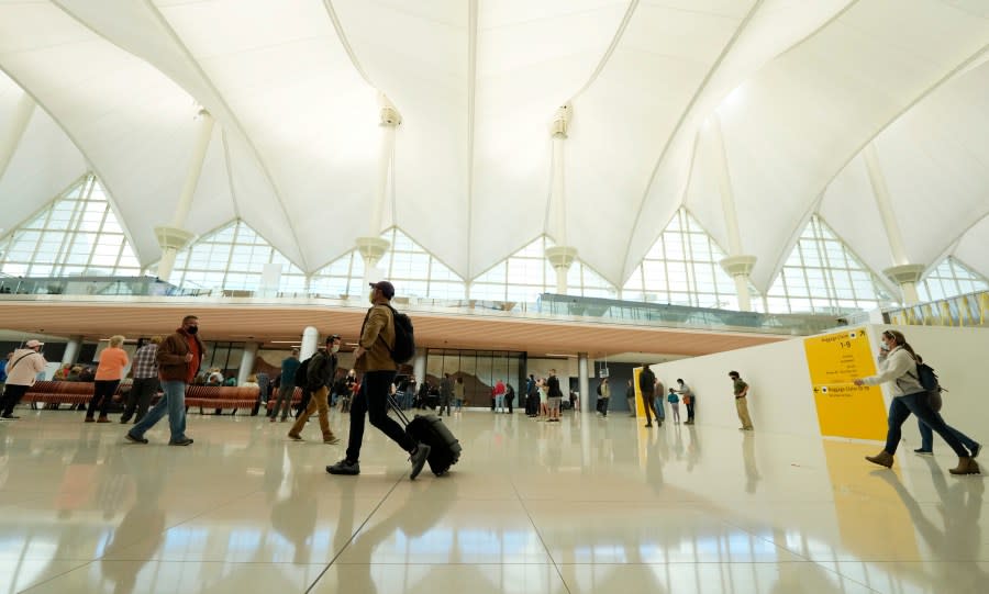 Travelers move through the main terminal at Denver International Airport