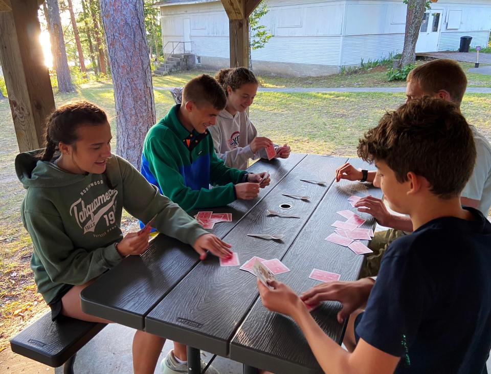 Campers come together for some cards during a four-day team camp period recently at Park of the Pines in Boyne City.