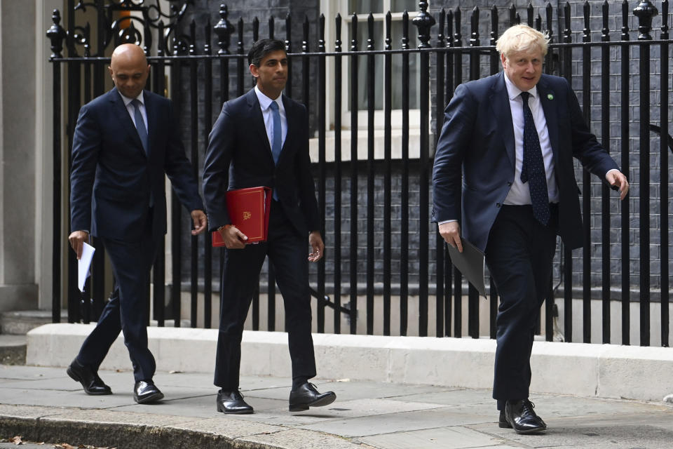 From left, British Health Secretary Sajid Javid, Chancellor of the Exchequer Rishi Sunak and Prime Minister Boris Johnson arrive at No 9 Downing Street for a media briefing on May 7, 2021. Two of Britain’s most senior Cabinet ministers have quit, a move that could spell the end of Prime Minister Boris Johnson’s leadership after months of scandals. Treasury chief Rishi Sunak and Health Secretary Sajid Javid resigned within minutes of each other. (Toby Melville/PA via AP)