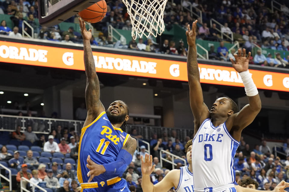 Pittsburgh guard Jamarius Burton (11) drives past Duke forward Dariq Whitehead (0) during the second half of an NCAA college basketball game at the Atlantic Coast Conference Tournament in Greensboro, N.C., Thursday, March 9, 2023. (AP Photo/Chuck Burton)