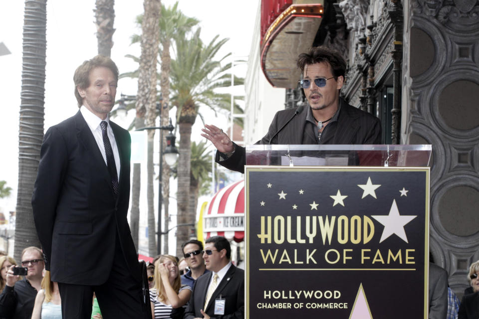 Actor Johnny Depp (R) speaks in tribute to film and television producer Jerry Bruckheimer during ceremonies honoring Bruckheimer with a star on the Hollywood Walk of Fame in Hollywood June 24, 2013. REUTERS/Fred Prouser  (UNITED STATES - Tags: ENTERTAINMENT)