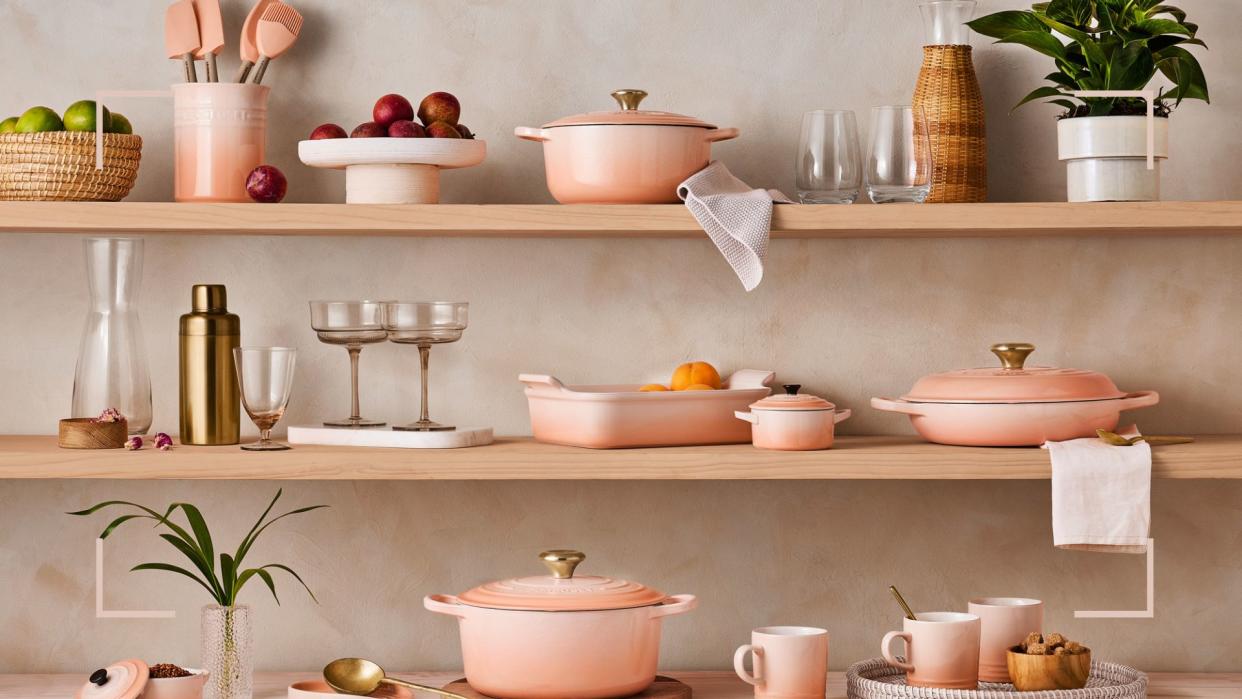  Kitchen shelves filled with the new Le Creuset Peche colour cookware and kitchen essentials. 