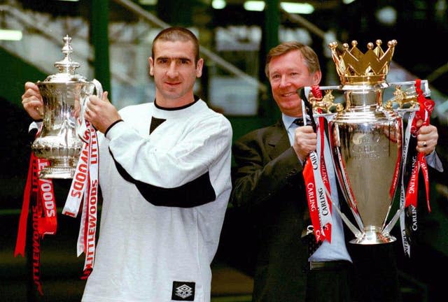 Eric Cantona and Sir Alex Ferguson (right) with the FA Cup and the Carling Premiership trophy