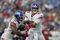 New York Giants quarterback Daniel Jones (8) hands off to running back Saquon Barkley (26) during the first half of the team's preseason NFL football game against the New England Patriots, Thursday, Aug. 11, 2022, in Foxborough, Mass. (AP Photo/Charles Krupa)