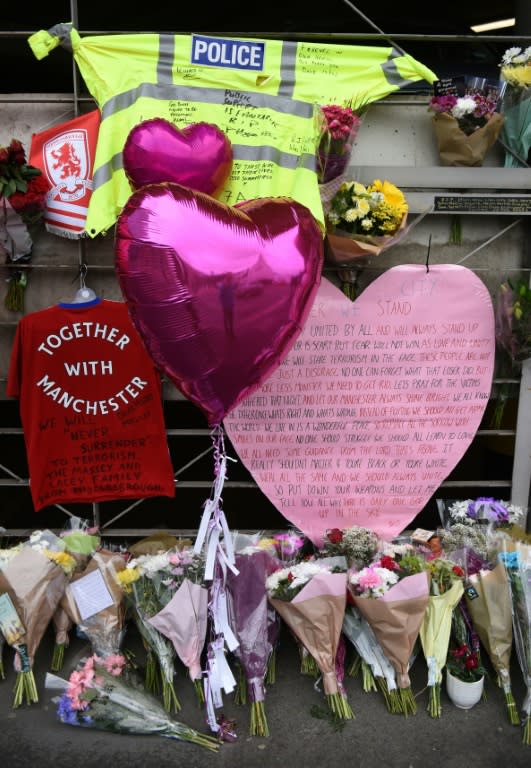 A police officer's hi-vis jacket, adorned with messages of support, outside Manchester Victoria station