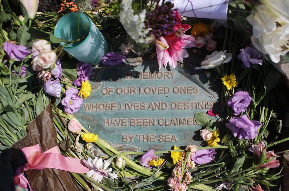 Flowers are laid at a memorial for persons lost at sea, at Santa Barbara Harbor, on Sept. 4, 2019 in Santa Barbara, California.