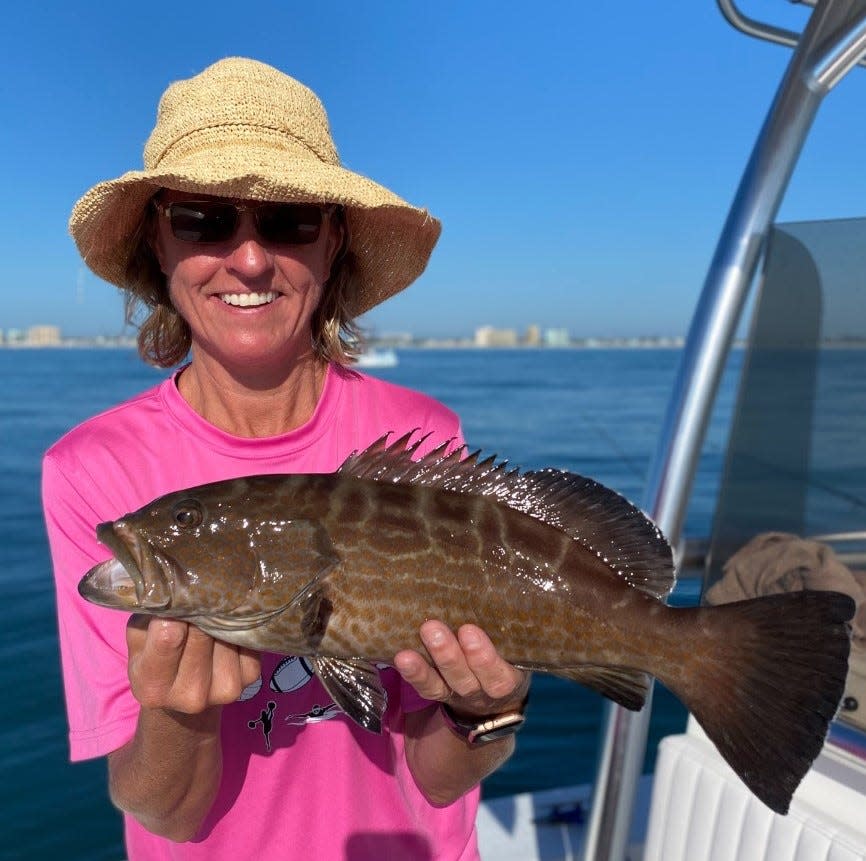 Capt. Jeff Patterson was surprised to see this client pull a black grouper to the boat from just offshore. They're more common much farther south, he says.