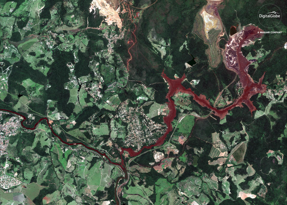 This Jan. 29, 2019 satellite image provided by DigitalGlobe shows mud flooding an area days after a mining company's dam collapsed on Jan. 25, near Brumadinho, Brazil. As search-and-recovery efforts continued, authorities also worked to slow the reddish-brown mud that was heading down a small river with high concentrations of iron oxide, threatening to contaminate a much larger waterway that provides drinking water to communities in five of the country’s 26 states. (DigitalGlobe, a Maxar company via AP)