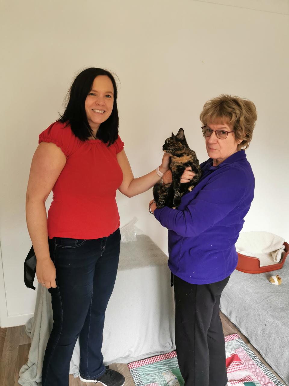 Minnie's new owner Thea Mumford with the cat and an RSPCA carer.