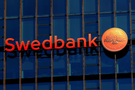 FILE PHOTO: Swedbank sign is seen on the building of the bank's Lithuanian headquarters in Vilnius, Lithuania March 30, 2019. REUTERS/Ints Kalnins/File Photo