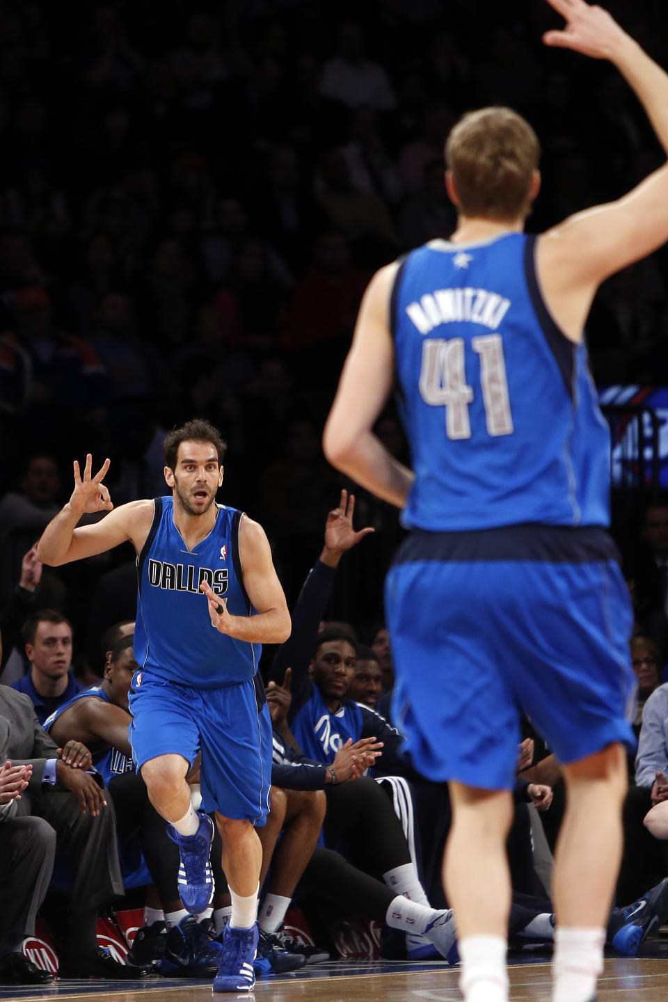 Dallas Mavericks' Jose Calderon, left celebrates with teammate Dirk Nowitzki (41) after scoring against the New York Knicks during the first half of an NBA basketball game, Monday, Feb. 24, 2014, in New York. (AP Photo/Jason DeCrow)