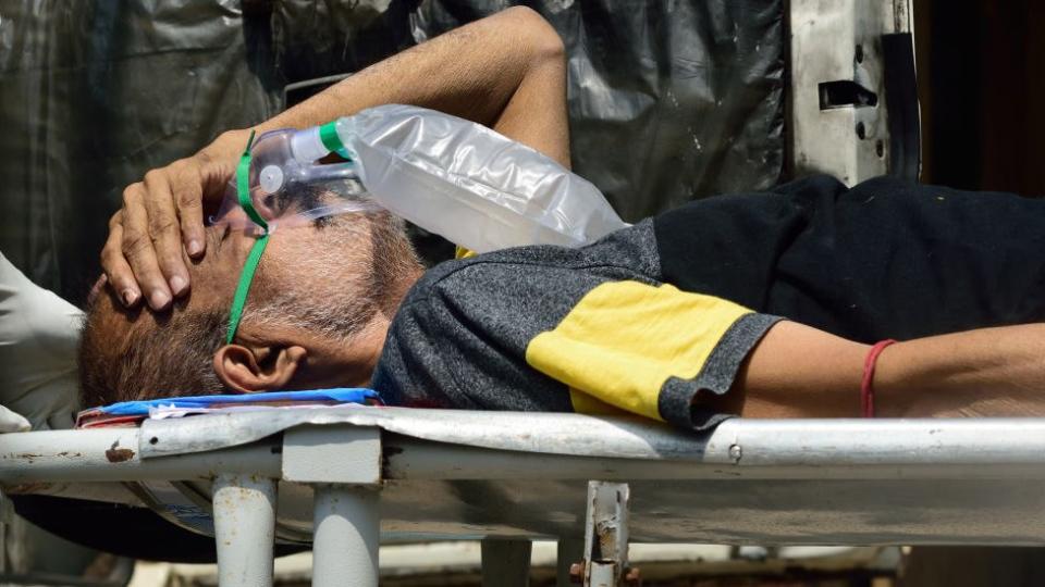 A Covid-19 patient wearing a medical oxygen mask being carried on a stretcher into a hospital before admission as pandemic situation has drastically deteriorated in the county in Kolkata, India on April 24, 2021