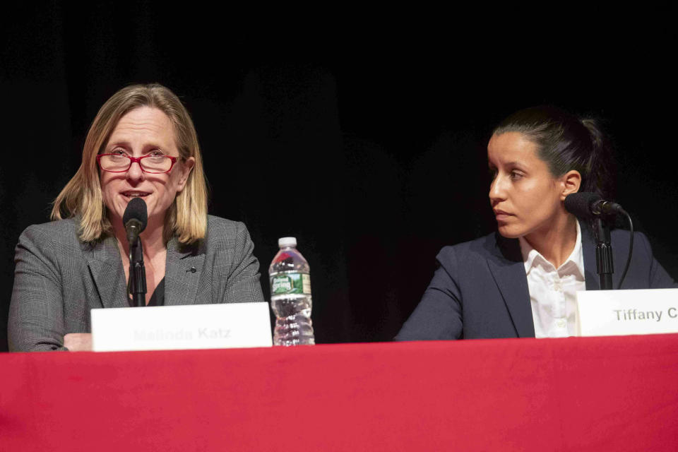 FILE - In this Thursday, June 13, 2019, file photo, public defender Tiffany Caban, right, listens as Queens Borough President Melinda Katz speaks during a Queens District Attorney candidates' forum at St. John's University in New York. The campaign between the two has become a test between left-wing and moderate Democrats. (AP Photo/Mary Altaffer, File)