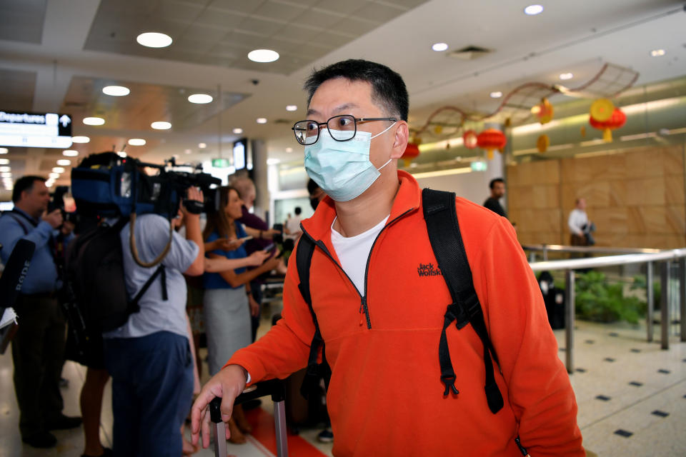 A passenger wearing a protective mask on arrival at Sydney International Airport in Sydney on Thursday. Source: AAP Image/Joel Carrett