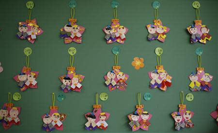 Paper crafts of Japanese ornamental "hina" dolls, made by children, are displayed on a wall at the Emporium kindergarten in Koriyama, west of the tsunami-crippled Fukushima Daiichi nuclear power plant, Fukushima prefecture February 28, 2014. REUTERS/Toru Hanai