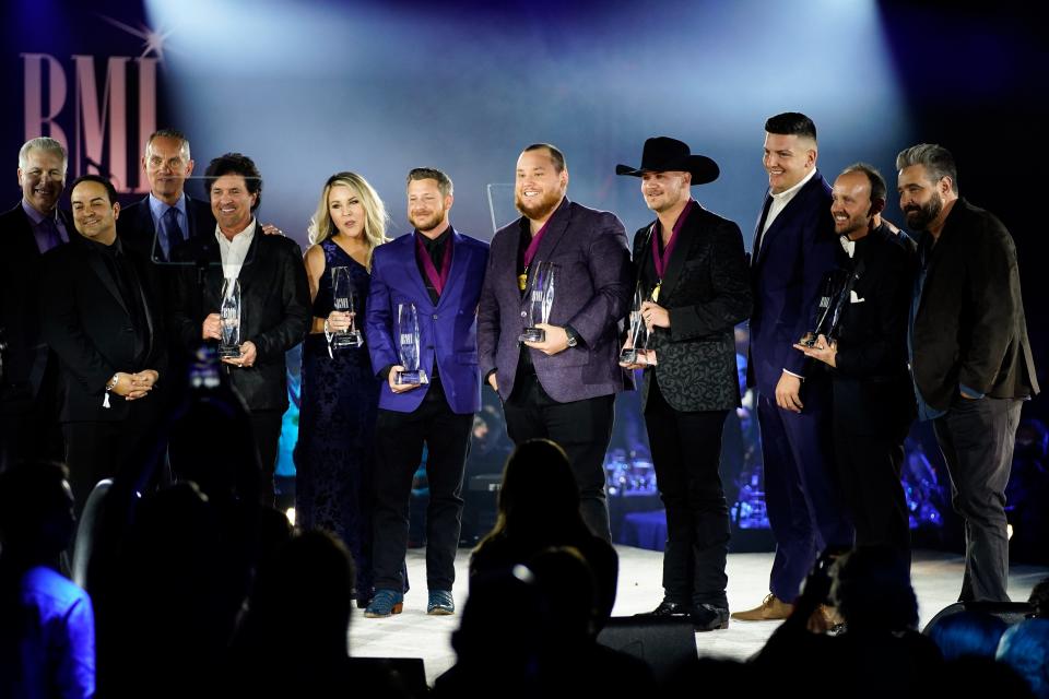 Luke Combs, center, and other winners accept their awards for the song Forever After All during the BMI’s 70th Annual Country Awards at the BMI Music Row Headquarters in Nashville, Tenn., Tuesday, Nov. 8, 2022.