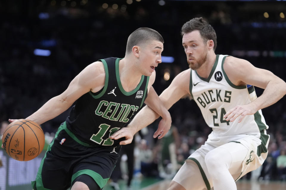 Boston Celtics guard Payton Pritchard (11) drives against Milwaukee Bucks guard Pat Connaughton (24) during the first half of an NBA basketball game Wednesday, March 20, 2024, in Boston. (AP Photo/Steven Senne)