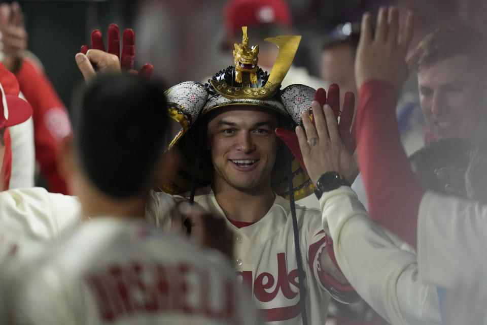 Los Angeles Angels' Logan O'Hoppe (14) wears a kabuto while celebrating in the dugout after hitting a home run during the sixth inning of a baseball game against the Washington Nationals in Anaheim, Calif., Tuesday, April 11, 2023. (AP Photo/Ashley Landis)