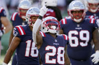 New England Patriots running back James White, center, celebrates his touchdown run against the Arizona Cardinals in the first half of an NFL football game, Sunday, Nov. 29, 2020, in Foxborough, Mass. (AP Photo/Elise Amendola)