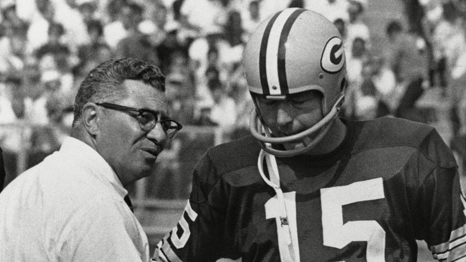 Mandatory Credit: Photo by Anonymous/AP/Shutterstock (6643320a)Green Bay Packer coach Vince Lombardi, center, speaks with quarterback Bart Starr (15) and Zeke Bratkowski, left, as the Packers trailed the Detroit Lions at Green Bay, .