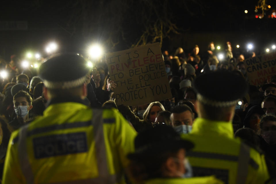 A woman holds up a placard as people gather in Clapham Common, London, after the Reclaim These Streets vigil for Sarah Everard was officially cancelled. Serving police constable Wayne Couzens, 48, has appeared in court charged with kidnapping and killing the marketing executive, who went missing while walking home from a friend's flat in south London on March 3. Picture date: Saturday March 13, 2021.