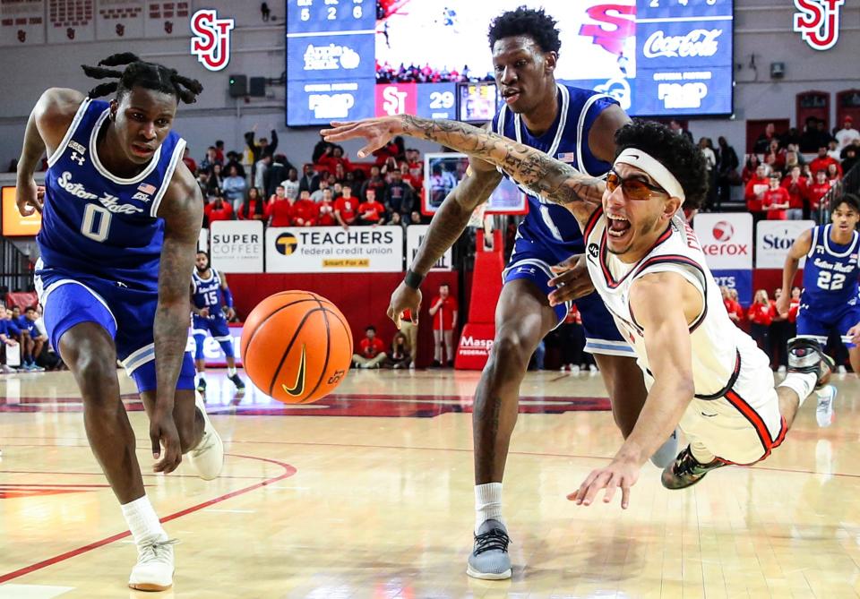 Seton Hall Pirates guard Kadary Richmond (0), forward Tyrese Samuel (4) and St. John's Red Storm guard Andre Curbelo (3) fight for a loose ball in the first half at Carnesecca Arena.