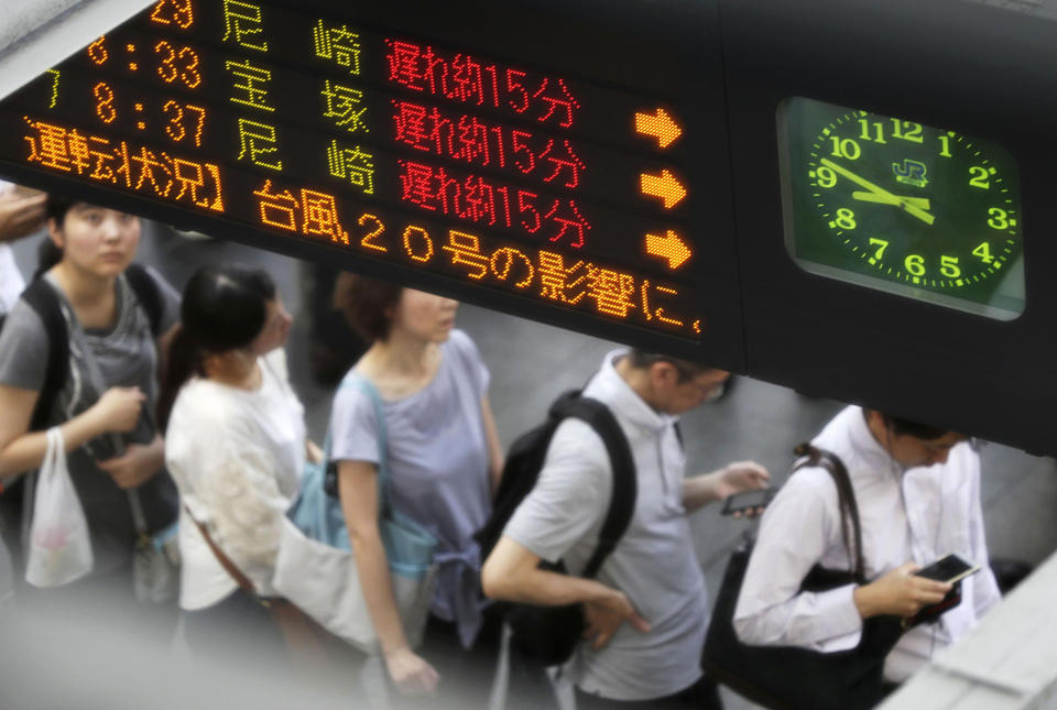 Passengers wait for delayed trains after Typhoon Cimarron hit the area at Osaka Station in Osaka, western Japan. (Takaki Yajima/Kyodo News via AP)