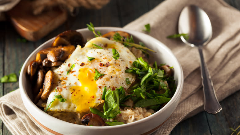 Oats with mushrooms and spinach with a spoon