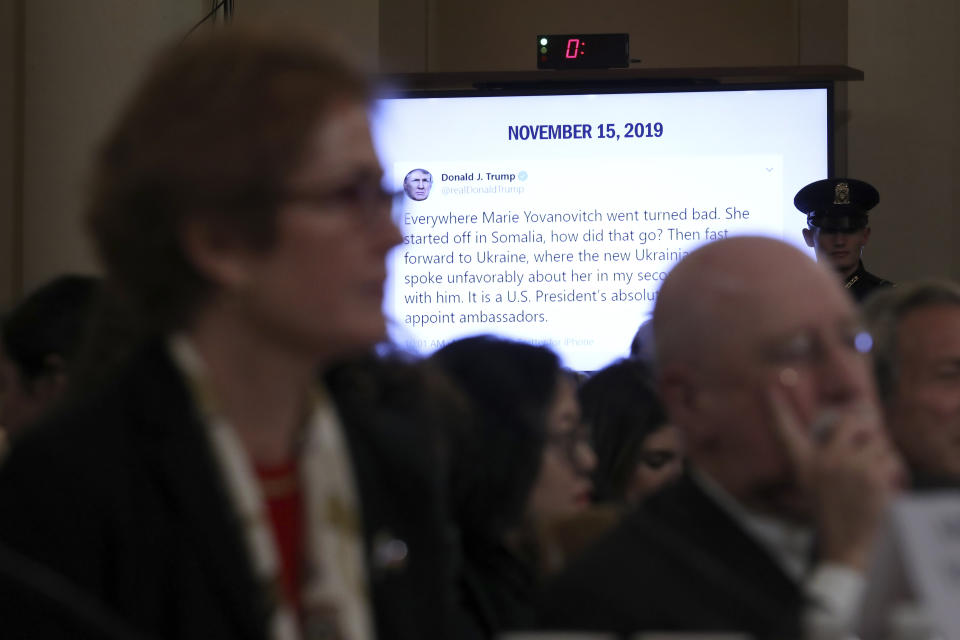 A tweet from President Donald Trump is displayed on a monitor as former U.S. Ambassador to Ukraine Marie Yovanovitch testifies before the House Intelligence Committee on Capitol Hill in Washington, Friday, Nov. 15, 2019, during the second public impeachment hearing of President Donald Trump's efforts to tie U.S. aid for Ukraine to investigations of his political opponents. (AP Photo/Andrew Harnik)