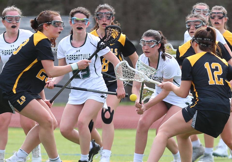 Lakeland/Panas and Pleasantville players battle for ball control during girls lacrosse action at Pleasantville High School April 7, 2023. Lakeland/Panas won the game 15-12.  