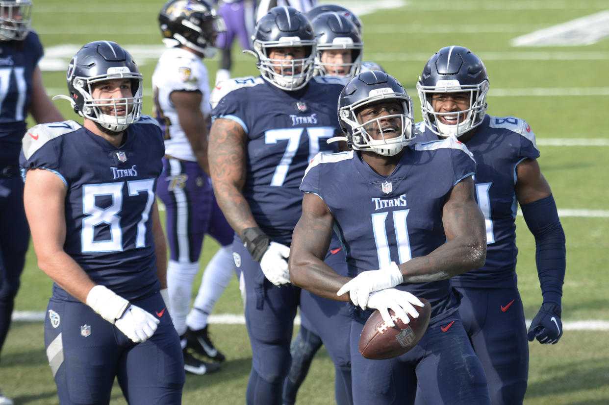 Tennessee Titans wide receiver A.J. Brown (11) celebrates after making a touchdown catch against the Baltimore Ravens in the first half of an NFL wild-card playoff football game Sunday, Jan. 10, 2021, in Nashville, Tenn. (AP Photo/Mark Zaleski)