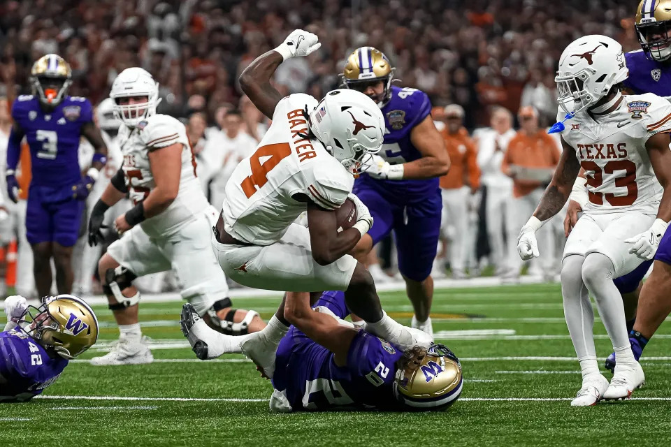 Texas Longhorns running back CJ Baxter (4) is tackled by <a class="link " href="https://sports.yahoo.com/ncaaf/teams/washington/" data-i13n="sec:content-canvas;subsec:anchor_text;elm:context_link" data-ylk="slk:Washington;sec:content-canvas;subsec:anchor_text;elm:context_link;itc:0">Washington</a> linebacker Carson Bruener (42) during the Sugar Bowl College Football Playoff semifinals game at the Caesars Superdome on Monday, Jan. 1, 2024 in New Orleans, Louisiana.