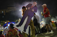 Followers of former Brazilian President Luiz Inacio "Lula" da Silva, who is running for president again, celebrate partial results after general election polls closed in Rio de Janeiro, Brazil, Sunday, Oct. 2, 2022. (AP Photo/Silvia Izquierdo)