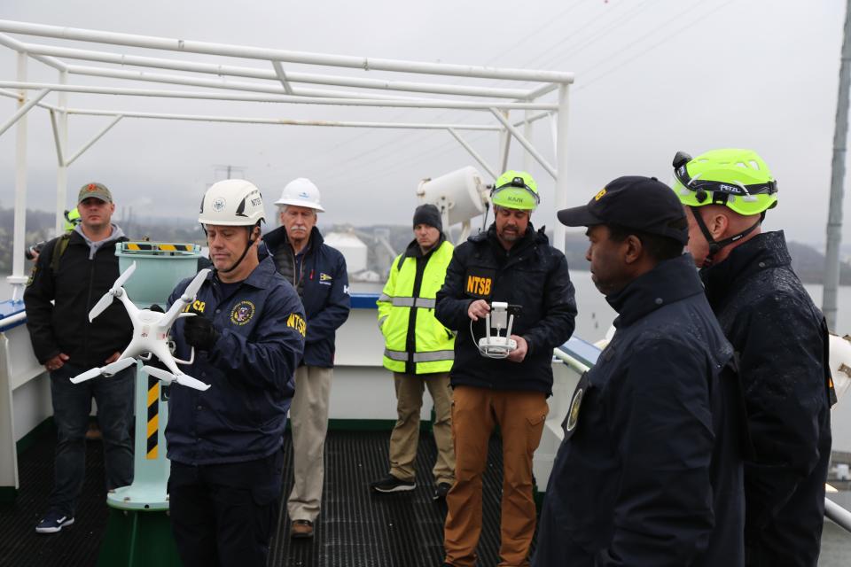 NTSB investigators are seen March 27, 2024, on the cargo vessel Dali, which struck and collapsed the Francis Scott Key Bridge on March 26, 2024.