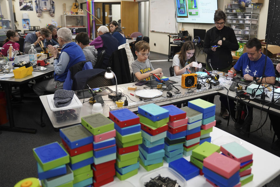 Workshop participants assemble LightSound devices at the New England Sci-Tech education center in Natick, Mass., on March 2, 2024. The creators of the device are working with other institutions with the goal of distributing at least 750 devices to locations hosting eclipse events in Mexico, the U.S., and Canada. (AP Photo/Mary Conlon)