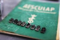 The dies from a tattoo kit, and a manual, are displayed at an Israeli auction house which says they were used on inmates at Auschwitz death camp, in Gilo