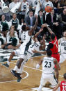 Michigan State's Rocket Watts, left, and Cassius Winston (5) and Ohio State's Luther Muhammad (1) battle for a rebound during the first half of an NCAA college basketball game, Sunday, March 8, 2020, in East Lansing, Mich. (AP Photo/Al Goldis)