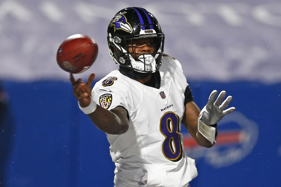 FILE - In this Jan. 16, 2021, file photo, Baltimore Ravens quarterback Lamar Jackson throws a pass during the first half of an NFL divisional round football game against the Buffalo Bills in Orchard Park, N.Y. The Ravens have exercised the fifth-year option for Jackson, the team announced Friday, April 30, 2021. (AP Photo/John Munson, File)